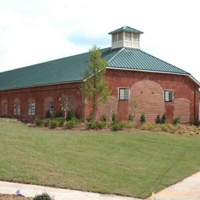 Snaplock forest green roofing over a red bricked property