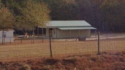 Shed with colony green roofing and sand walls