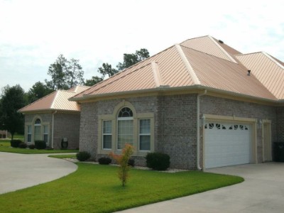 Copper metallic rib roofing over a brick-walled house